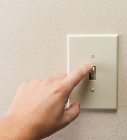 photo of person turning off a light