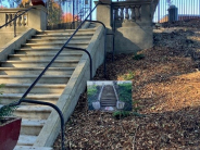 Concrete staircase with black handrails