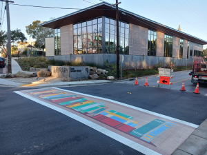 Crosswalk painting of books leading to library at the intersection of Clares street and Wharf Road